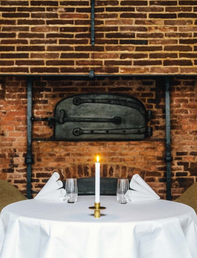 A table next to the old bakery oven, in 2 star Michelin restaurant Vinkeles, in luxury boutique hotel Royal Gate Resort.