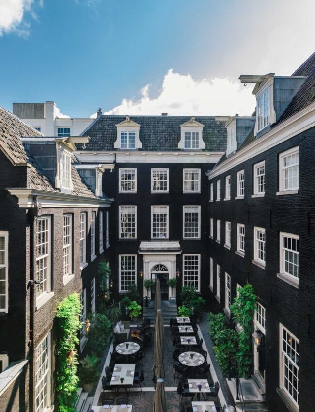 Royal Gate Resort central courtyard, historic canal-house hotel with outdoor seating, a member of Leading Hotels of the World.